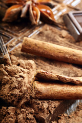 Christmas decor with dark chocolate coffee beans cinnamon nuts and star anise and empty place for text