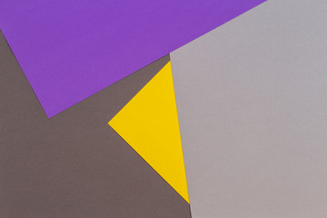 Abstract geometric paper texture cardboard background. Top view of purple violet yellow gray trendy colors tones
