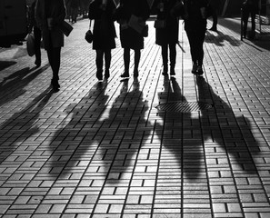 Silhouettes of people walking the streets of a big city