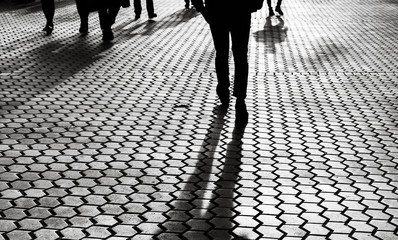 Silhouettes of people walking the streets of a big city