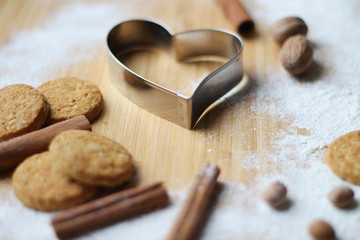 Great Cookies. Heart biscuit cutter bake tool on white and wooden background. Christmas concept....