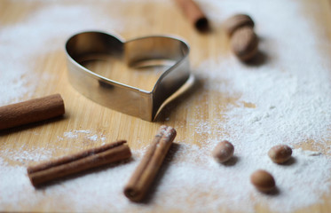 Great Cookies. Heart biscuit cutter bake tool on white and wooden background. Christmas concept. Template