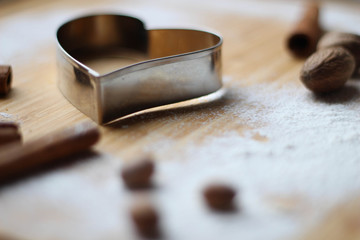 Great Cookies. Heart biscuit cutter bake tool on white and wooden background. Christmas concept. Template