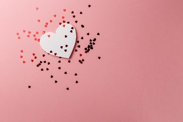 Creative photo. Valentine's Day postcard. Valentine's Day Background. Heart with confetti on pink background. Copy space. Top view. Flat lay. Pastel colors