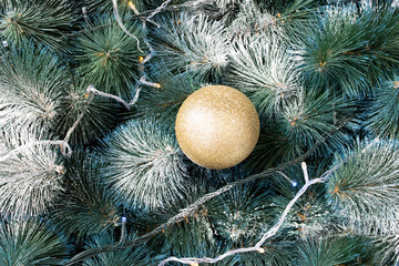 golden ball on a christmas tree close-up