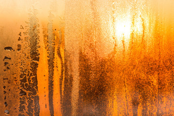 Beautiful texture of drops on the glass on a sunset. Water drops on the window. Background