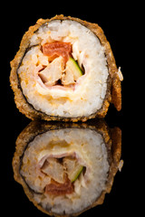 hot sushi roll in reflection closeup isolated on black 