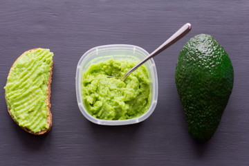 a paste of avocados and avocado on dark background