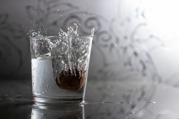 walnut in a glass with a spray of water