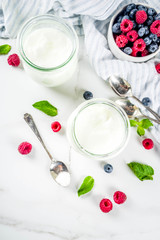 Two portion of yogurt with berries