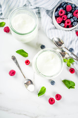Obraz na płótnie Canvas Two portion of yogurt with berries