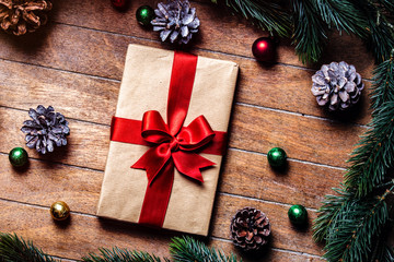 Christmas gift boxes and pine branch on wooden table. Hight angle point of view