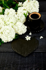 Cup of coffee with bouquet flower hydrangea and slate heart