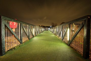 Metal footbridge at night