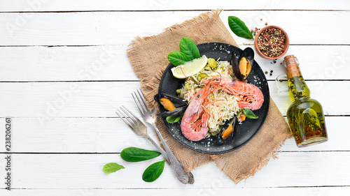 Risotto Rice with vegetables and seafood. Shrimp and mussels. On the old background. Top view. Free space for your text.