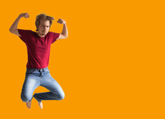 Fototapeta na wymiar teenager boy jumping dance movement on a colored yellow background
