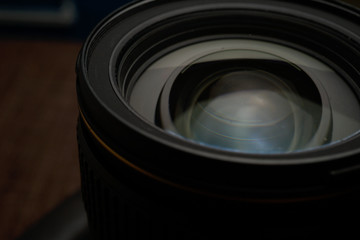 Close up of modern digital camera lense, a view of the front lens with flare effects