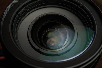Close up of modern digital camera lense, a view of the front lens with flare effects