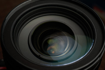 Close up of modern digital camera lense, a view of the front lens with flare effects