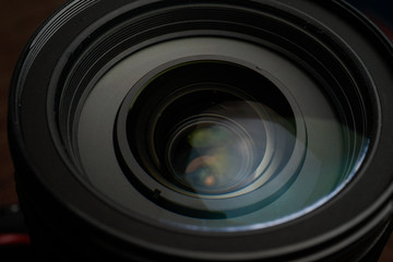 Close up of modern digital camera lense, a view of the front lens with flare effects