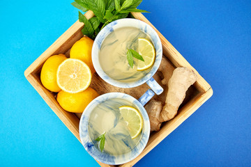 Healthy tea two cups with lemon, ginger, mint