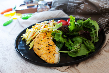 close-up of plate of pasta and chicken with lettuce