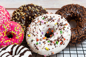 Decorated chocolate donuts on a baking grid