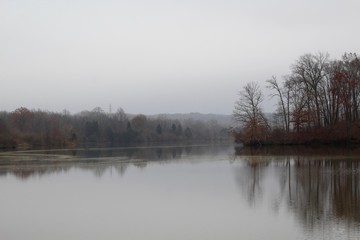 A view of the lake on a misty foggy late autumn day.