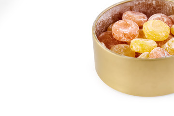 Colored round candy in powdered sugar. Bright candy.