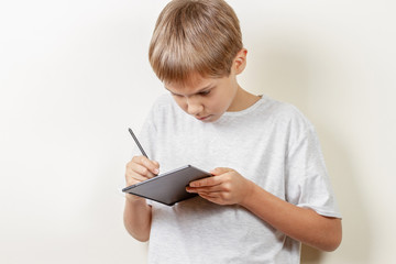 Kid drawing with graphic tablet and stylus pen