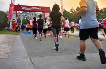 Lots of People  running in ChiangMai Marathon at Royal Park.  The runners  running arrive finish ...