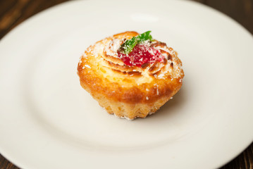 cake in a plate on a wooden background