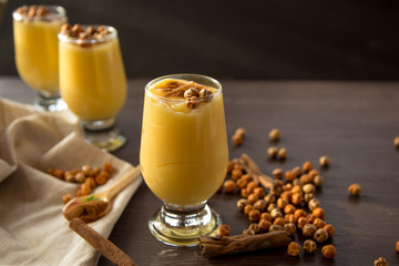 boza or bosa, a traditional Turkish drink roasted chickpeas and cinnamon on the brown table