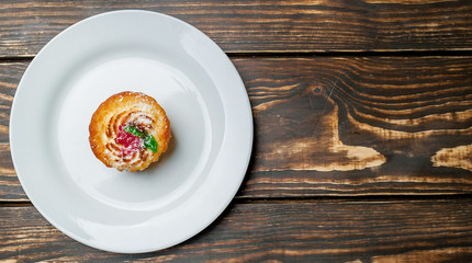 cake in a plate on a wooden background
