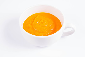 Pumpkin soup in a bowl on a white background
