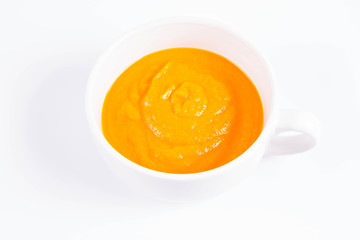 Pumpkin soup in a bowl on a white background