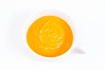 Pumpkin soup in a bowl on a white background