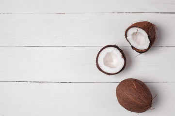Coconuts on a white wooden background. Exotic fruit