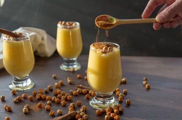 boza or bosa, a traditional Turkish drink roasted chickpeas and cinnamon on the brown table