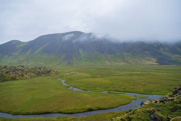 A river snakes through a wide valley on Iceland's Hornstrandir Peninsula