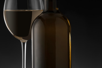 White wine bottle and glass on the black background