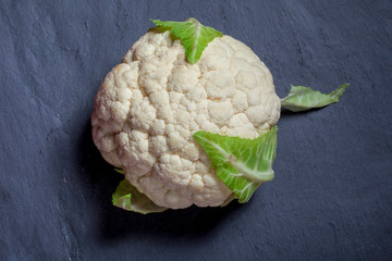 Cauliflower. Whole fresh cabbage on black background