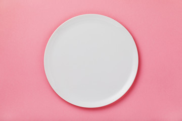 White ceramic tray on the pink table, top view. Food background