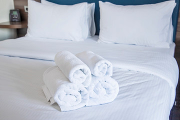 Fototapeta na wymiar Clean towels on bed. Selected focus.