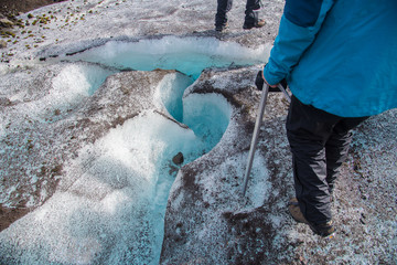 Hikers avoid a large crevice on Iceland's Falljokull Glacier Tongue