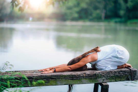 Yoga Woman by The Lake. Balasana