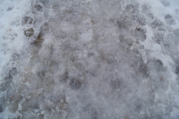 Obraz premium Background of ice with human footprints and snow.