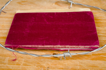 Old passport  surrounded by barbed wire
