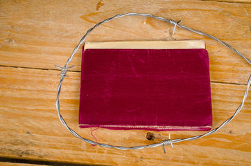 Old passport  surrounded by barbed wire