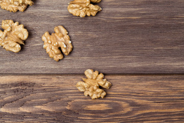 Obraz na płótnie Canvas Walnuts on the wooden background. Diet and culinary concept. Top view, flat lay, copy space